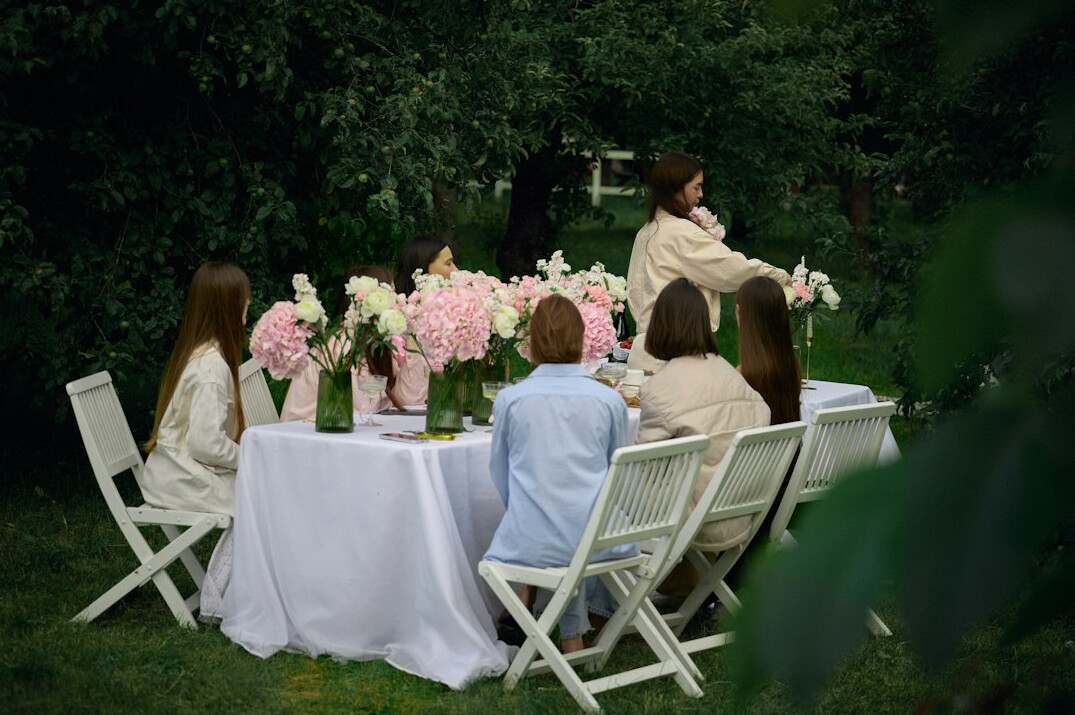 Small editorial team discussing content around a table in a bright office