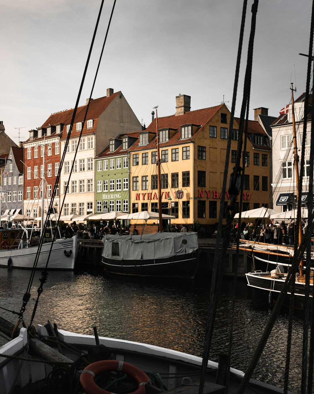 Colorful waterfront houses and boats along a Copenhagen canal